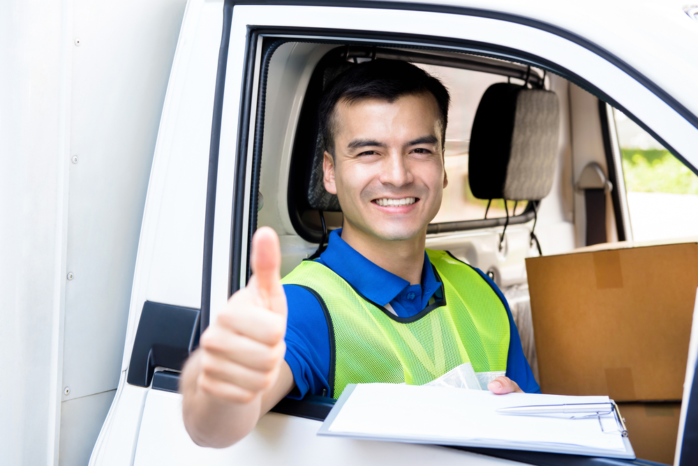 Smiling,Delivery,Man,Sitting,In,The,Car,As,A,Driver,